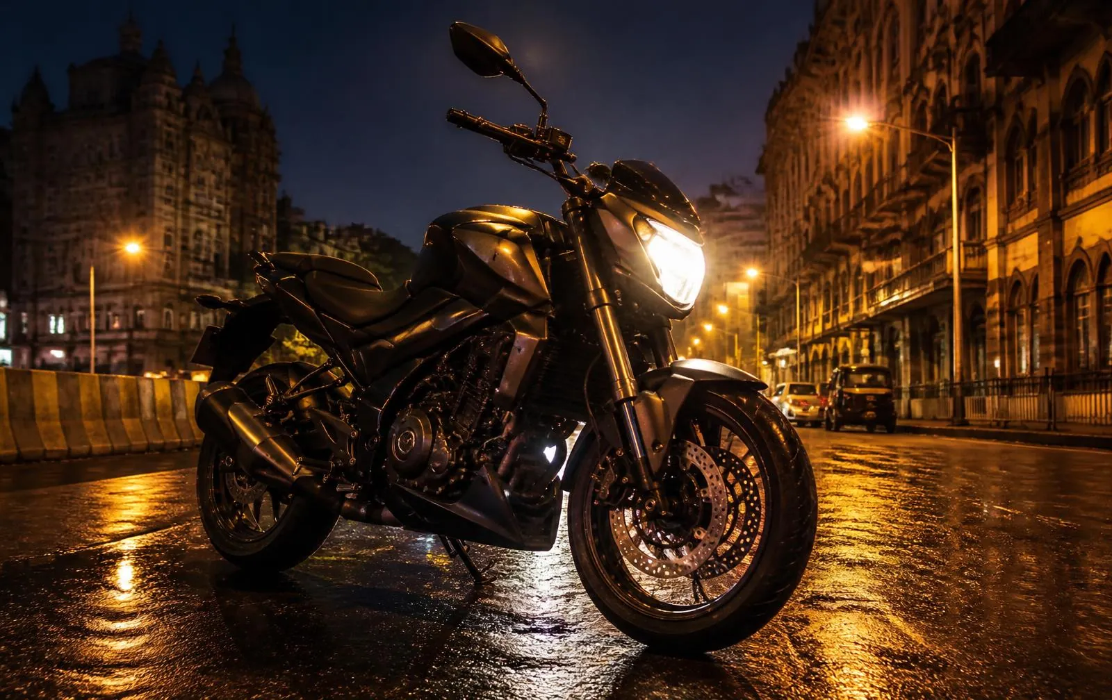 Naked motorcycle parked on a wet Indian city street at dusk
